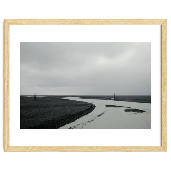 River passing through a black volcanic road - Iceland
