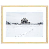 Footprints and house in winter snowscape thumbnail