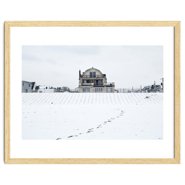 Footprints and house in winter snowscape