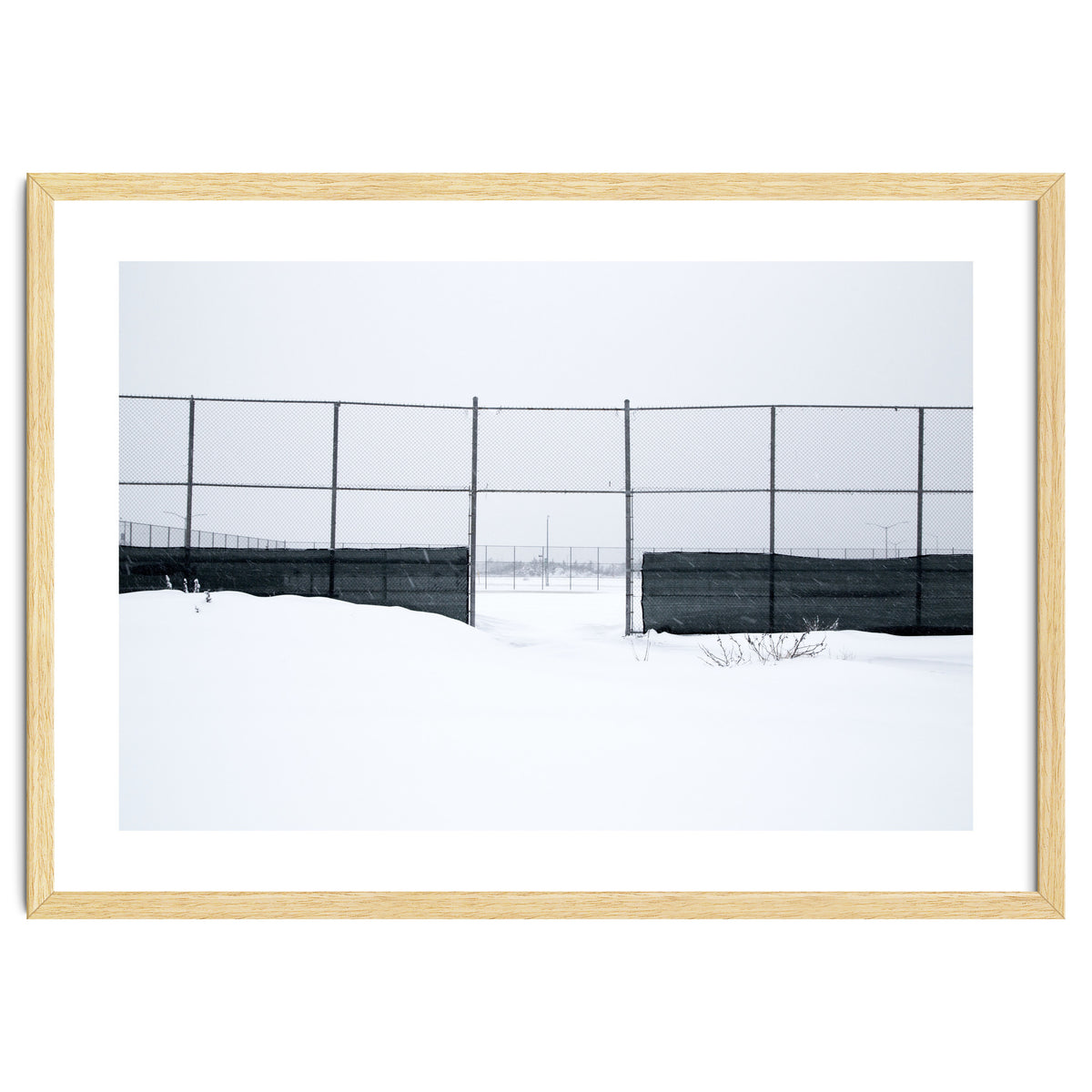 The entrance gate of the snow-covered baseball field