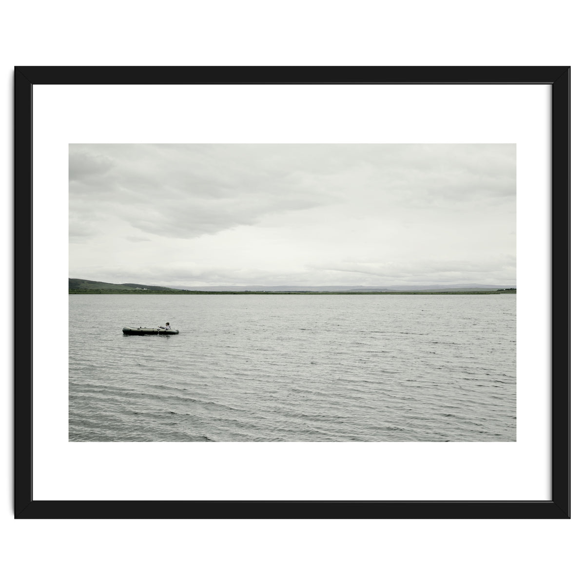 A boy pedaling the Board on the Lake - Iceland
