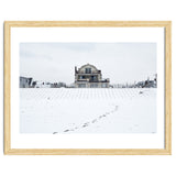 Footprints and house in winter snowscape thumbnail