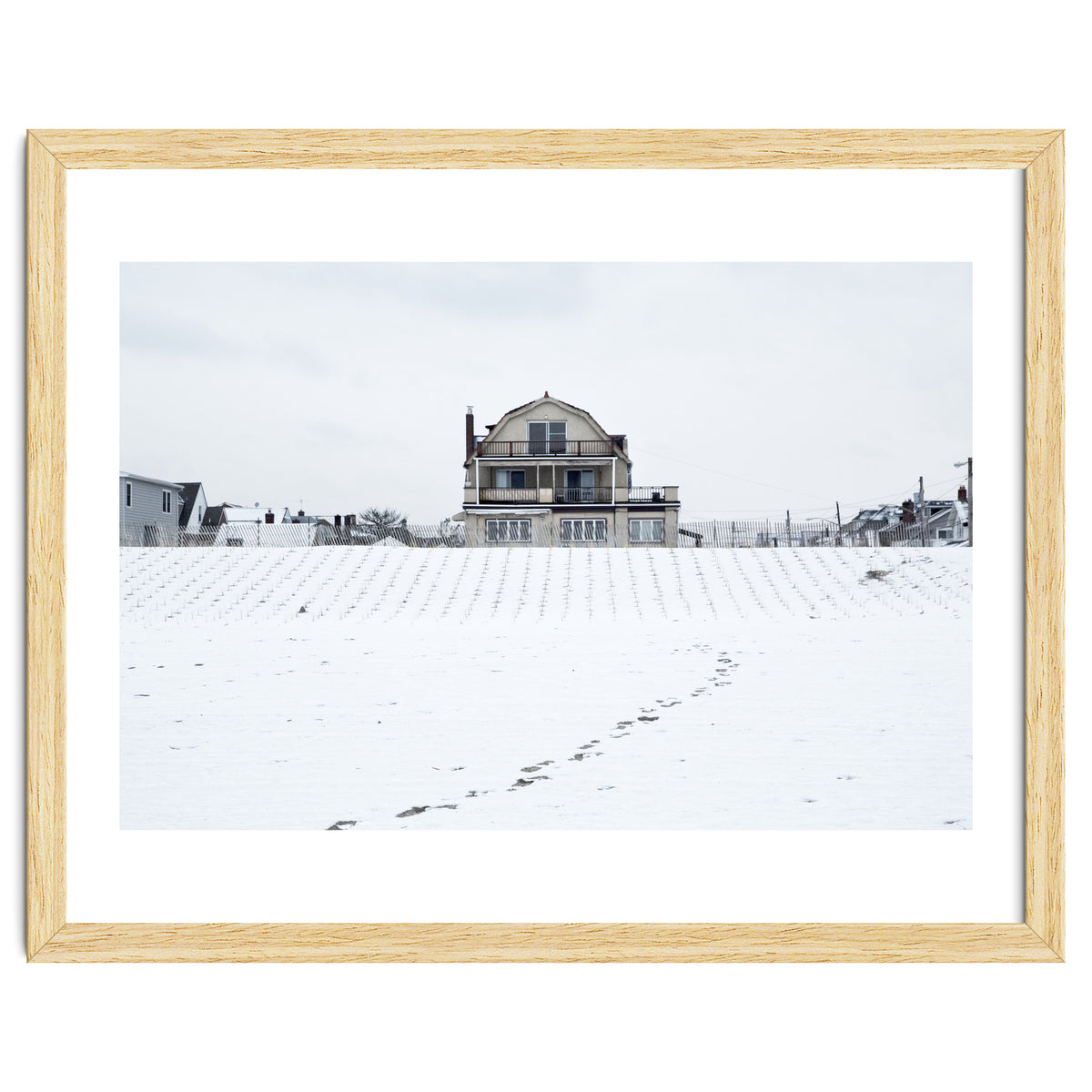 Footprints and house in winter snowscape