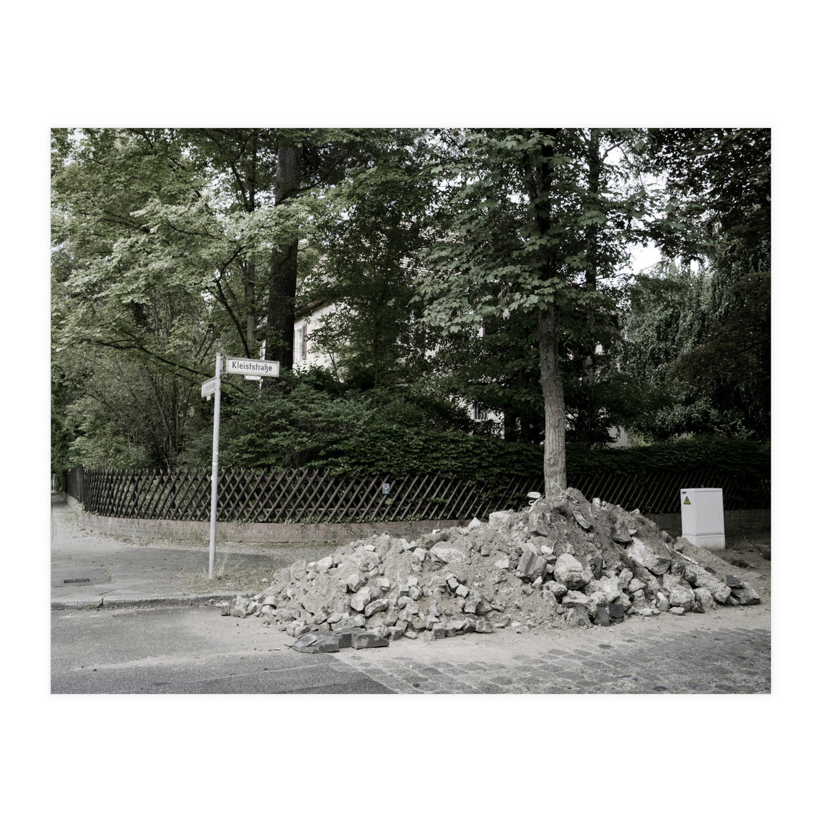 Piled-up rocks under construction on the street (Print Only)