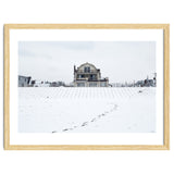 Footprints and house in winter snowscape thumbnail