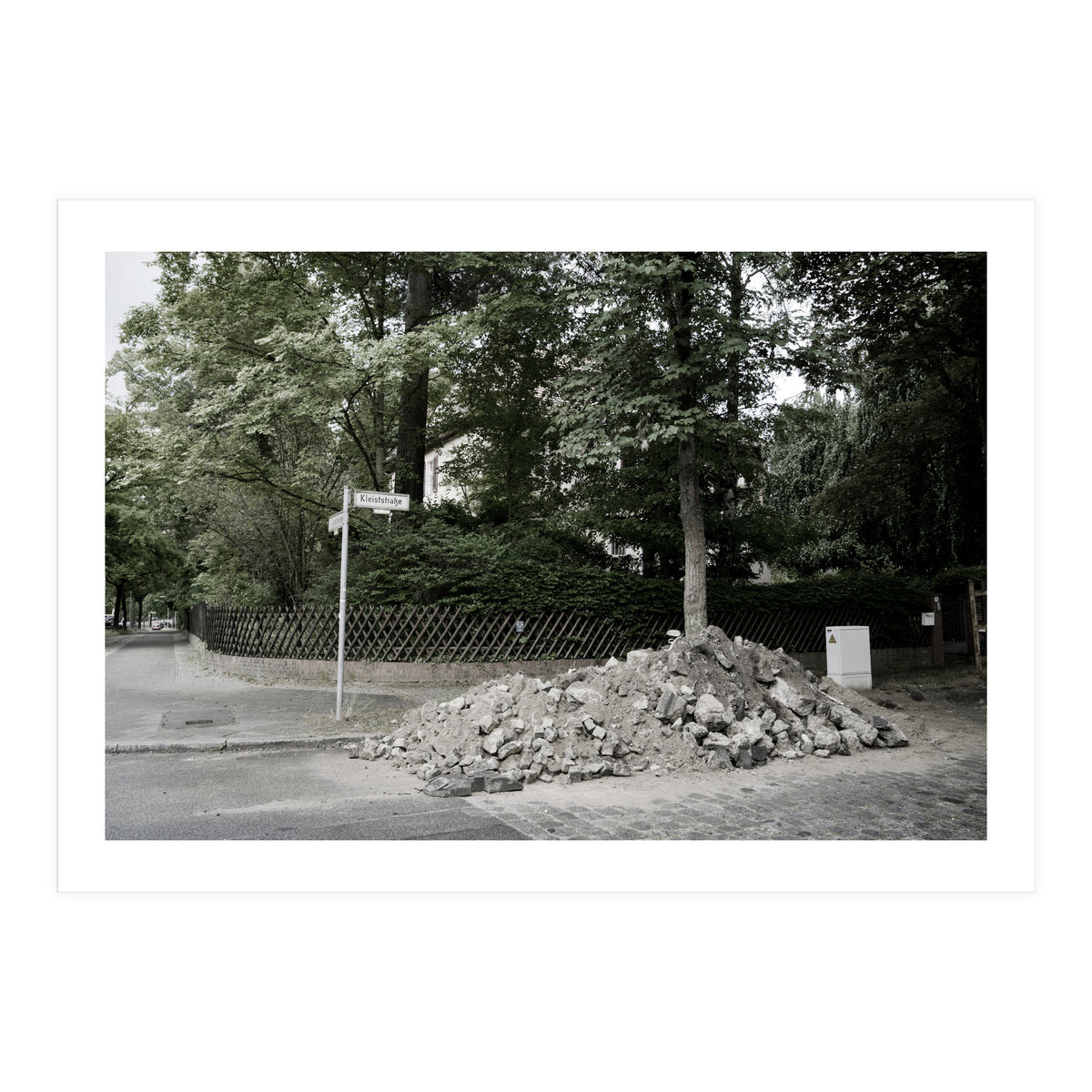 Piled-up rocks under construction on the street (Print Only)