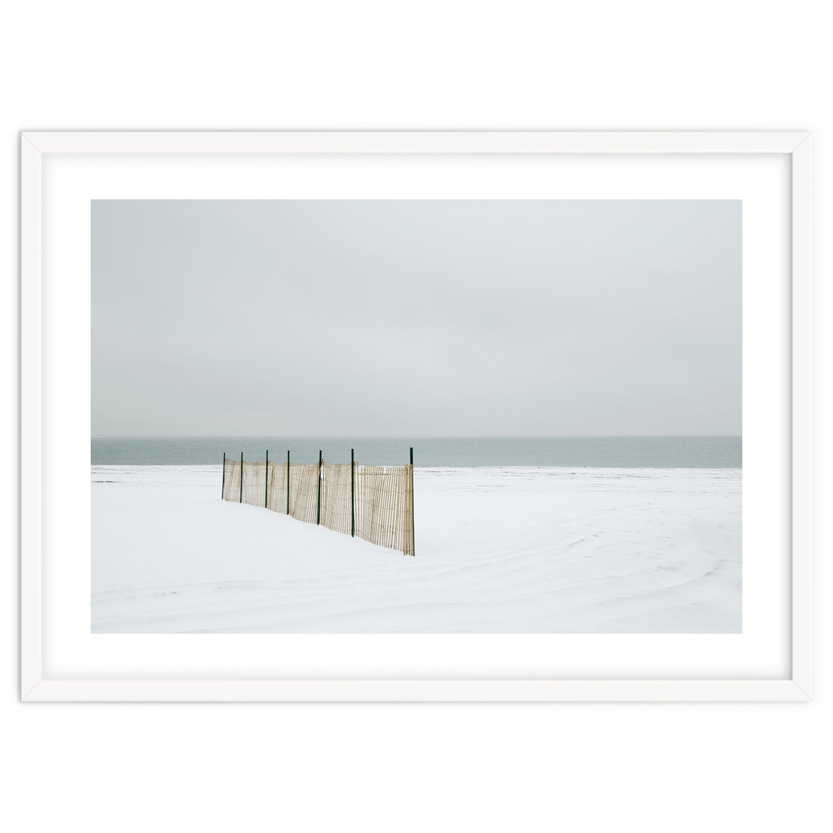 Wood fence in the winter snow beach