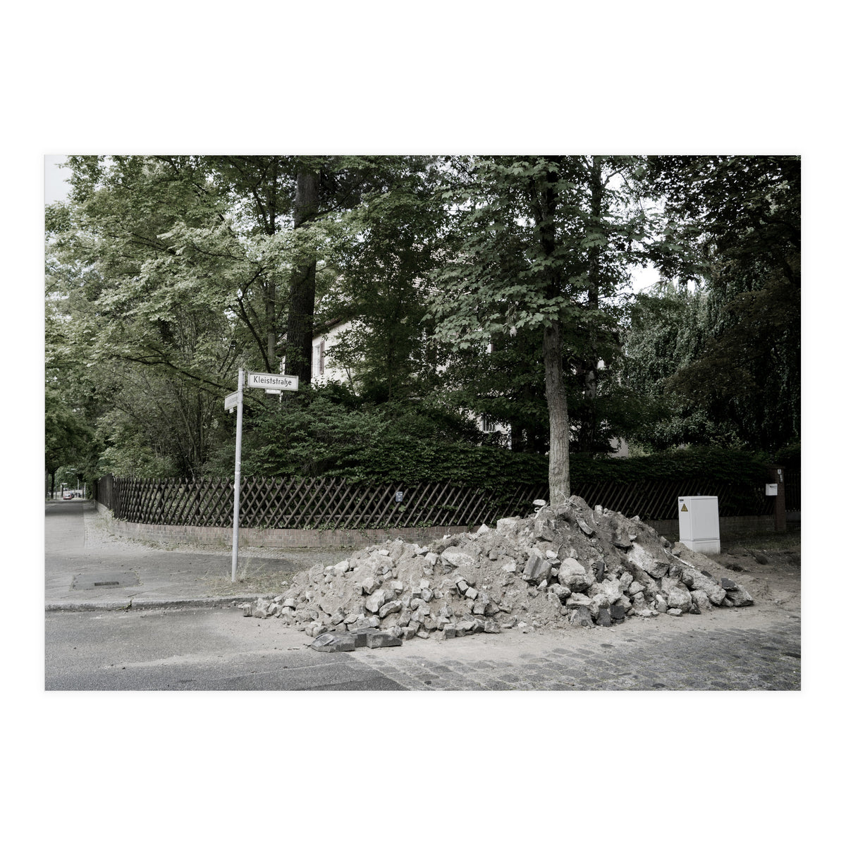 Piled-up rocks under construction on the street (Print Only)