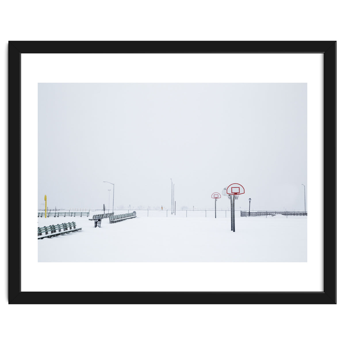 Snow-covered Basketball court and side bench