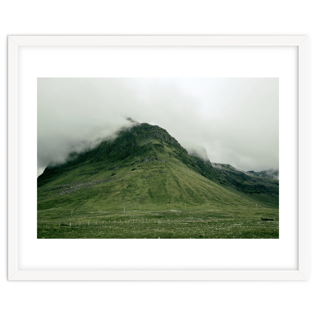 Green mountain covered in clouds - Iceland