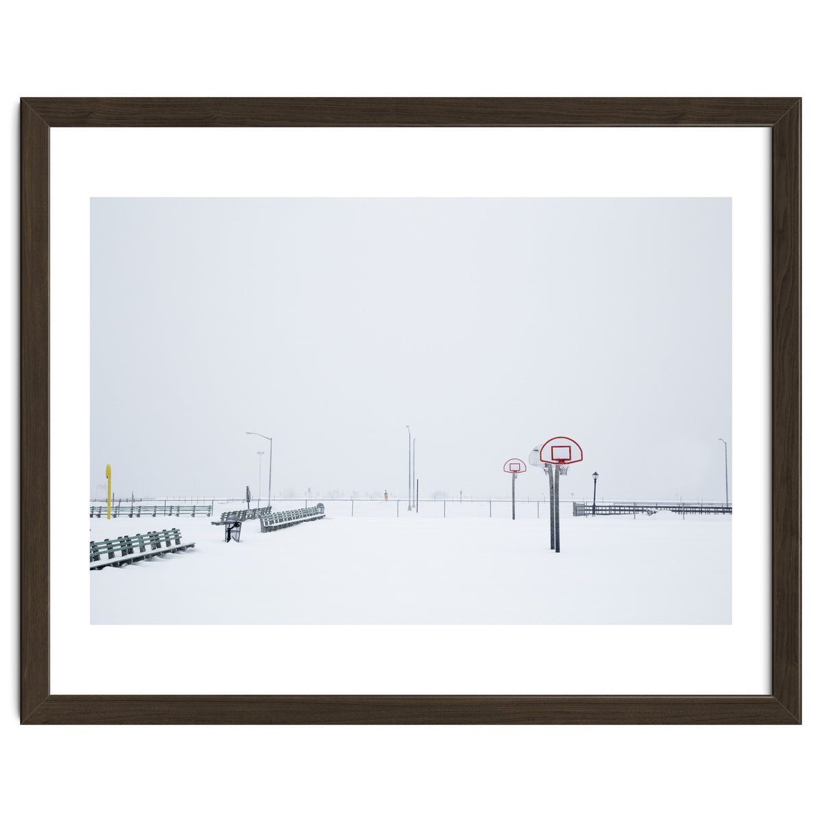 Snow-covered Basketball court and side bench