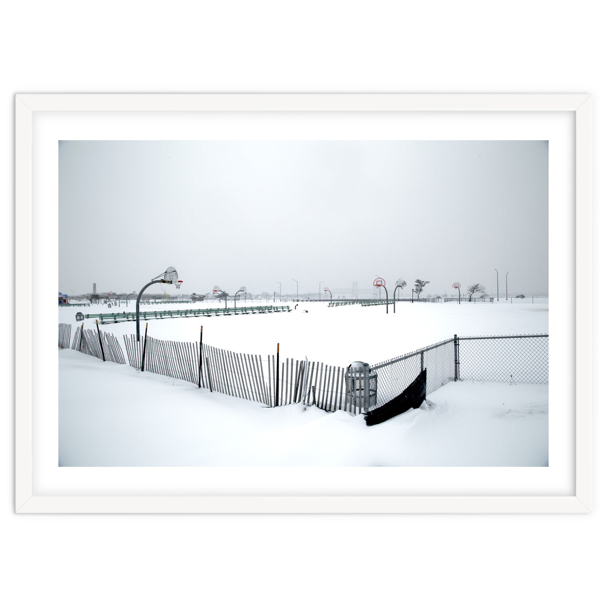 Snow-covered deserted basketball court in winter