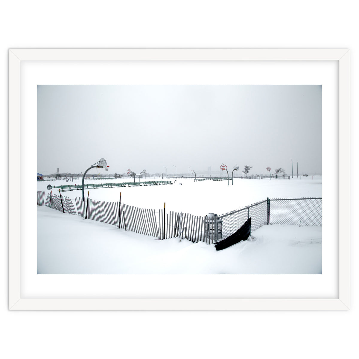 Snow-covered deserted basketball court in winter
