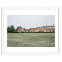 Red roof houses in the green field