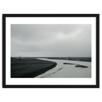 River passing through a black volcanic road - Iceland