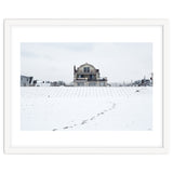 Footprints and house in winter snowscape thumbnail