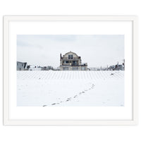 Footprints and house in winter snowscape