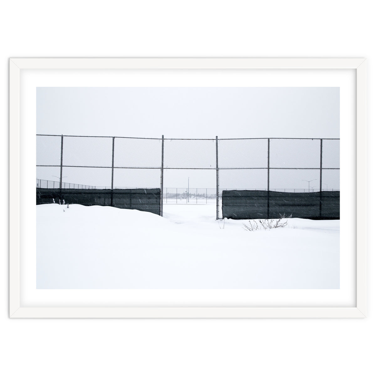The entrance gate of the snow-covered baseball field