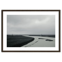 River passing through a black volcanic road - Iceland