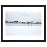 A seagull and snow covered houses