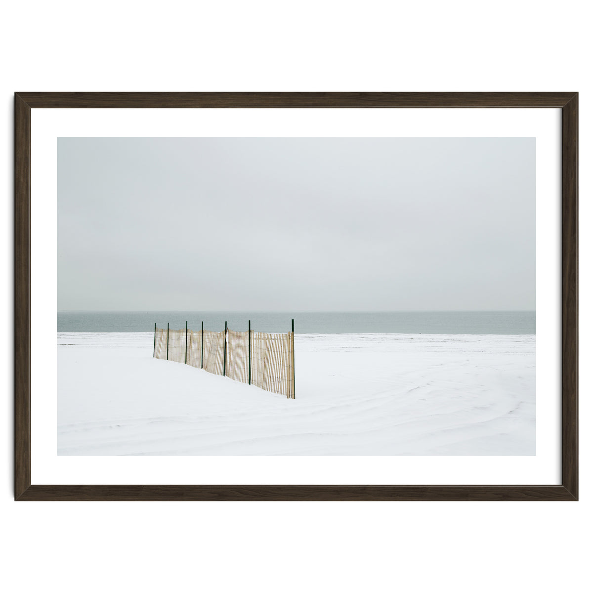 Wood fence in the winter snow beach