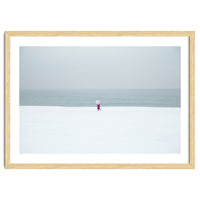 A walking woman in the winter snow beach