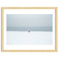 A walking woman in the winter snow beach