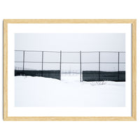 The entrance gate of the snow-covered baseball field