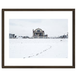 Footprints and house in winter snowscape thumbnail