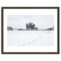 Footprints and house in winter snowscape