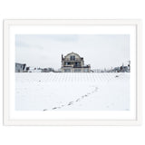 Footprints and house in winter snowscape thumbnail
