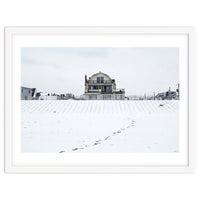 Footprints and house in winter snowscape