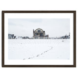 Footprints and house in winter snowscape thumbnail