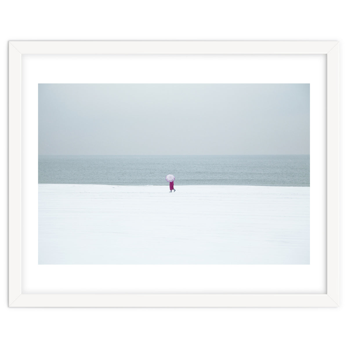 A walking woman in the winter snow beach