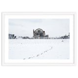 Footprints and house in winter snowscape thumbnail