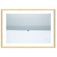 A walking woman in the winter snow beach