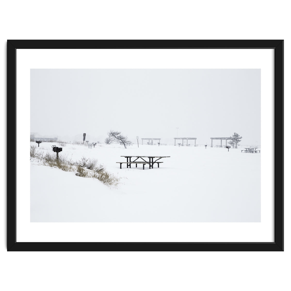 Tables and benches in a snow-covered park