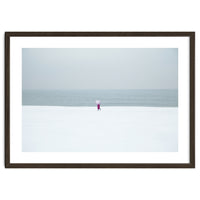 A walking woman in the winter snow beach