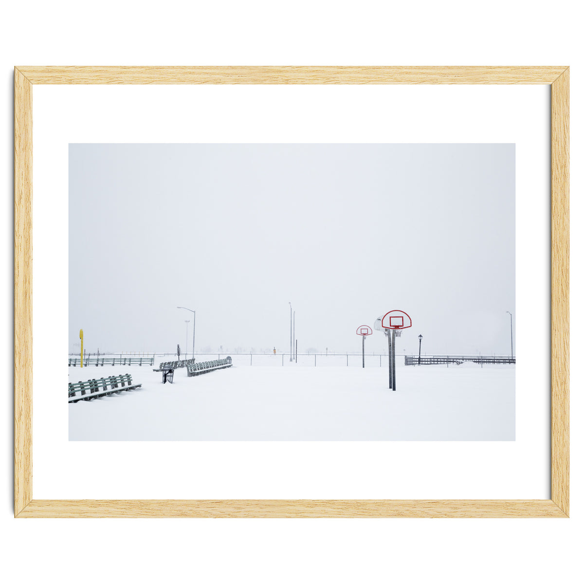 Snow-covered Basketball court and side bench
