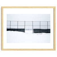 The entrance gate of the snow-covered baseball field