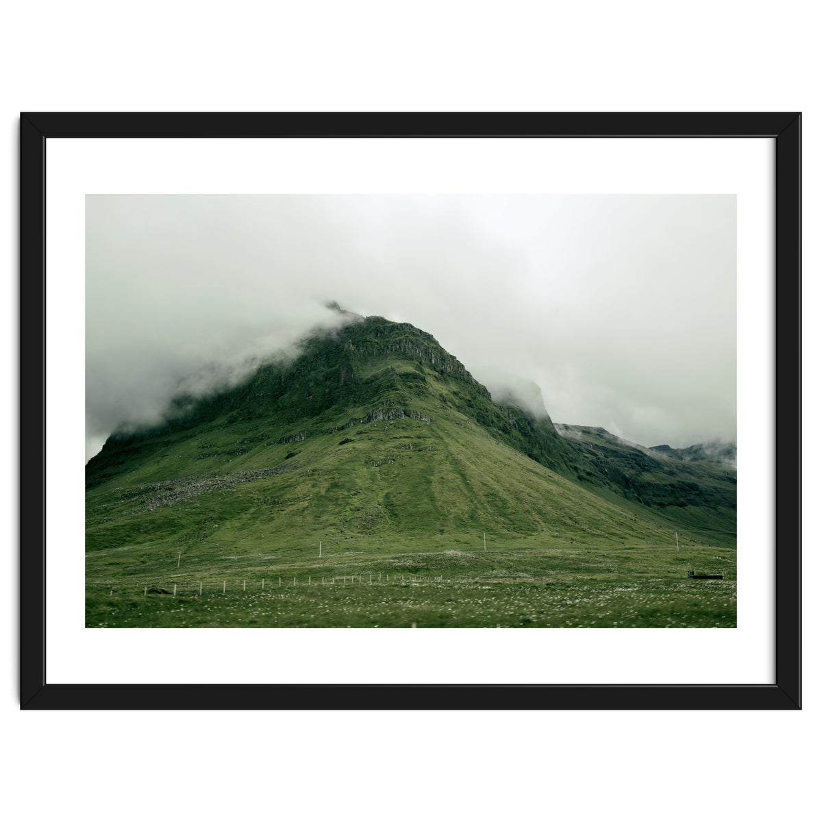 Green mountain covered in clouds - Iceland
