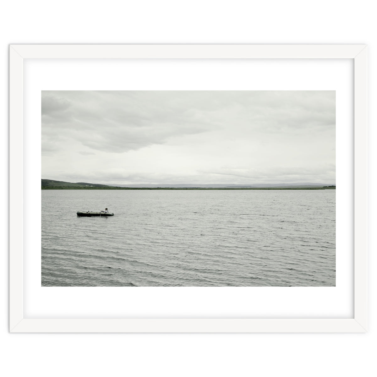 A boy pedaling the Board on the Lake - Iceland