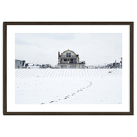 Footprints and house in winter snowscape