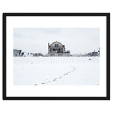 Footprints and house in winter snowscape thumbnail