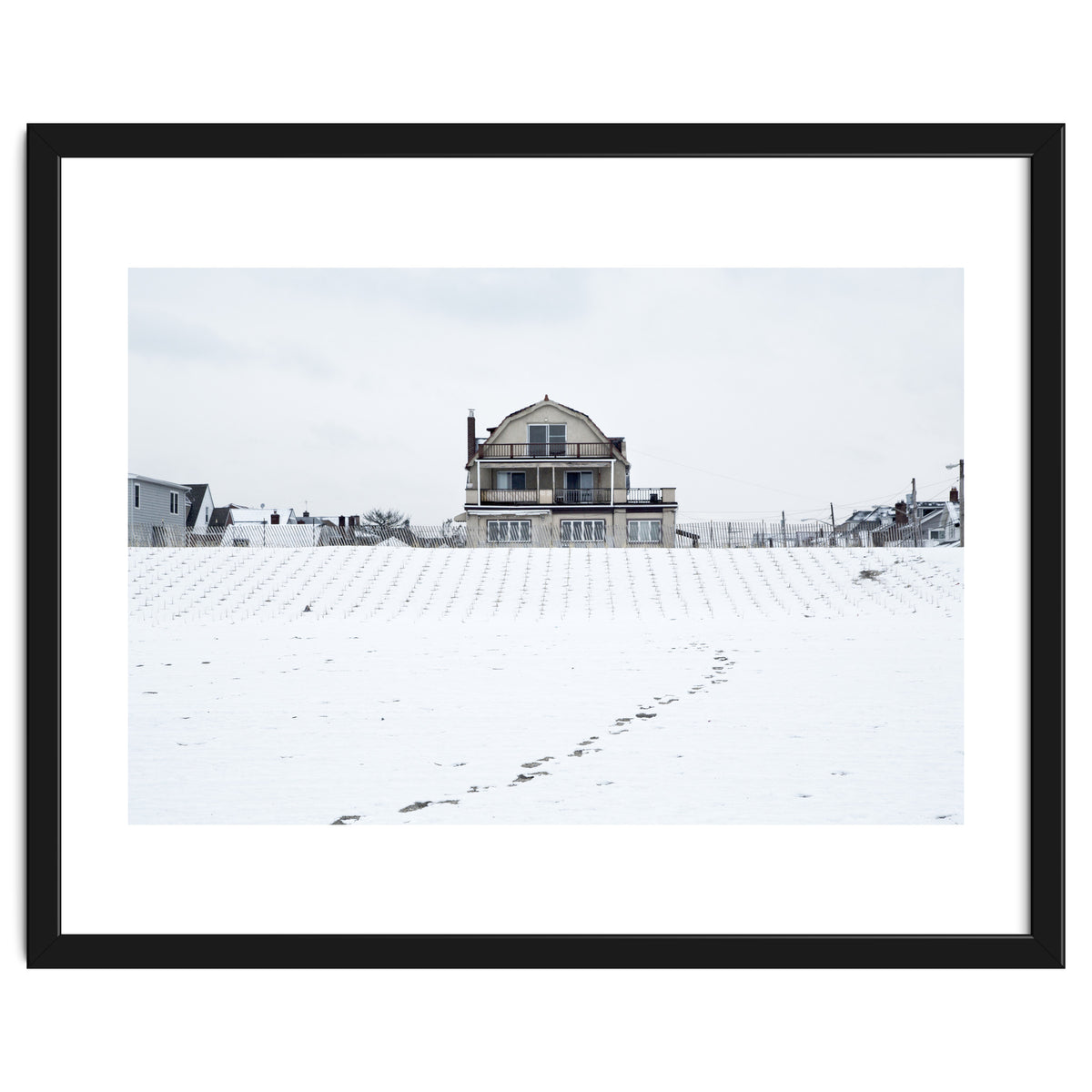 Footprints and house in winter snowscape