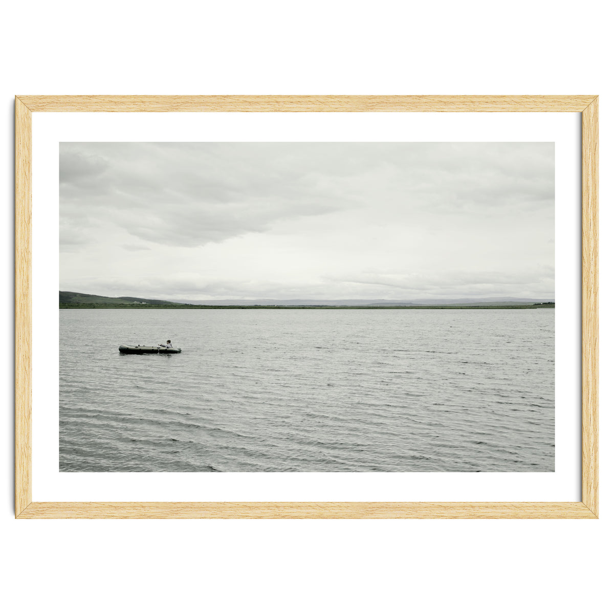A boy pedaling the Board on the Lake - Iceland