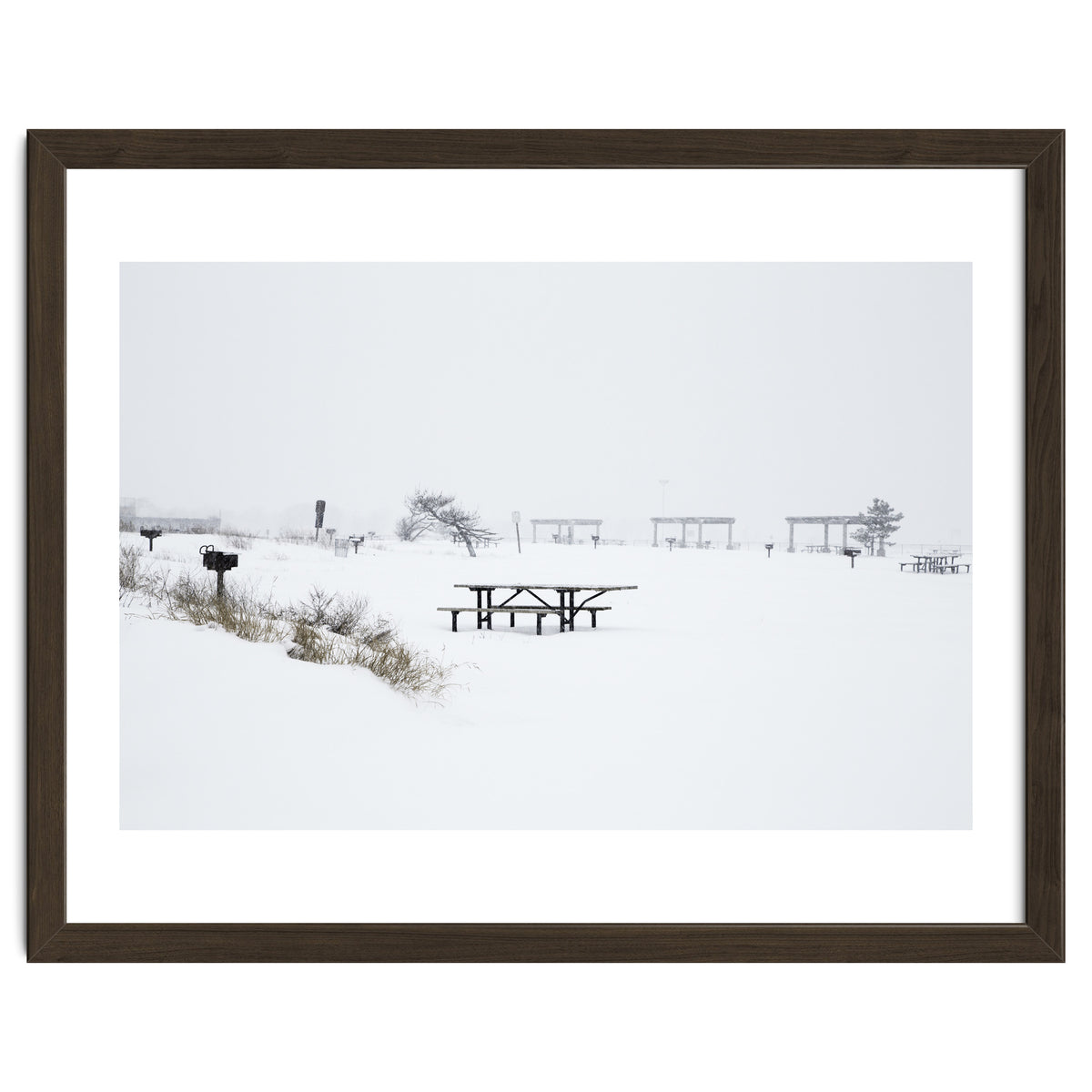 Tables and benches in a snow-covered park