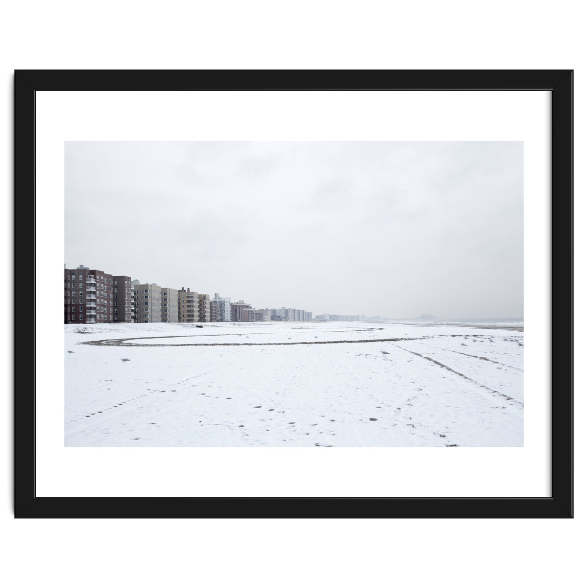 Traces of driving a car on a snowy coast