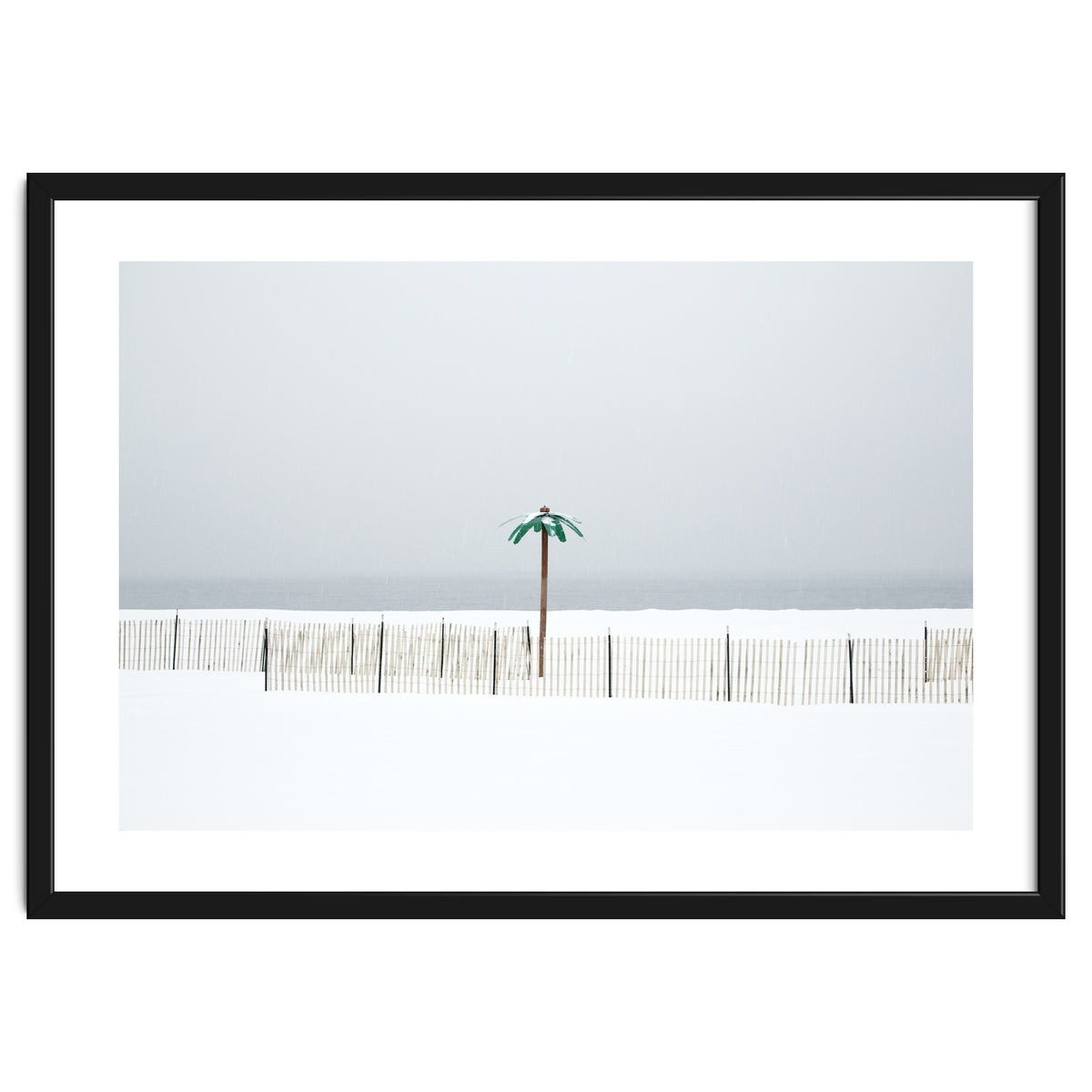Fake palm tree in the winter snow beach
