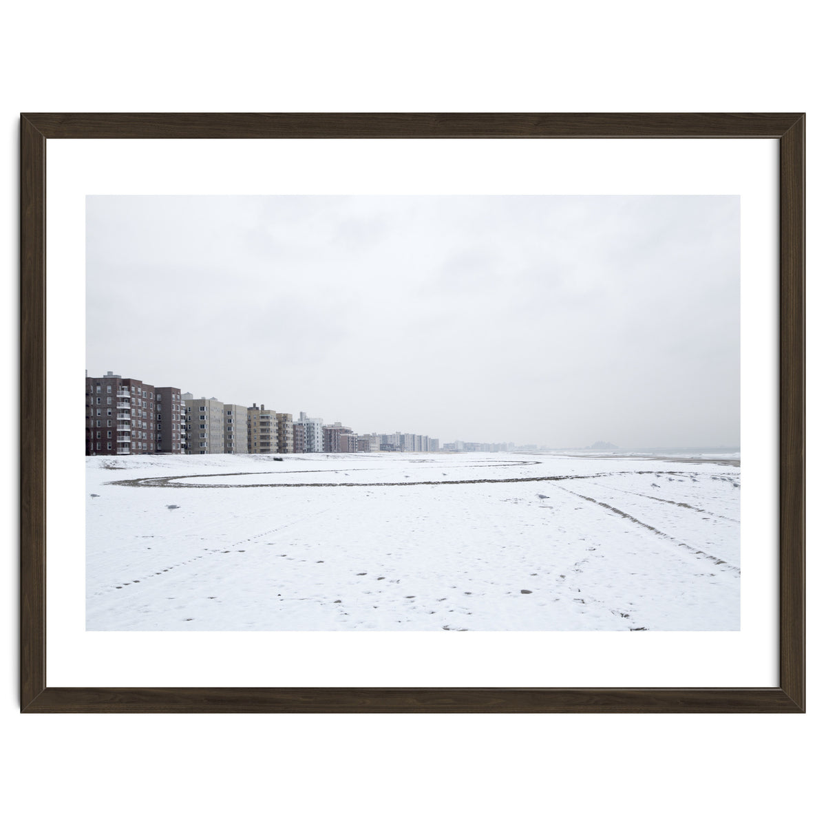 Traces of driving a car on a snowy coast